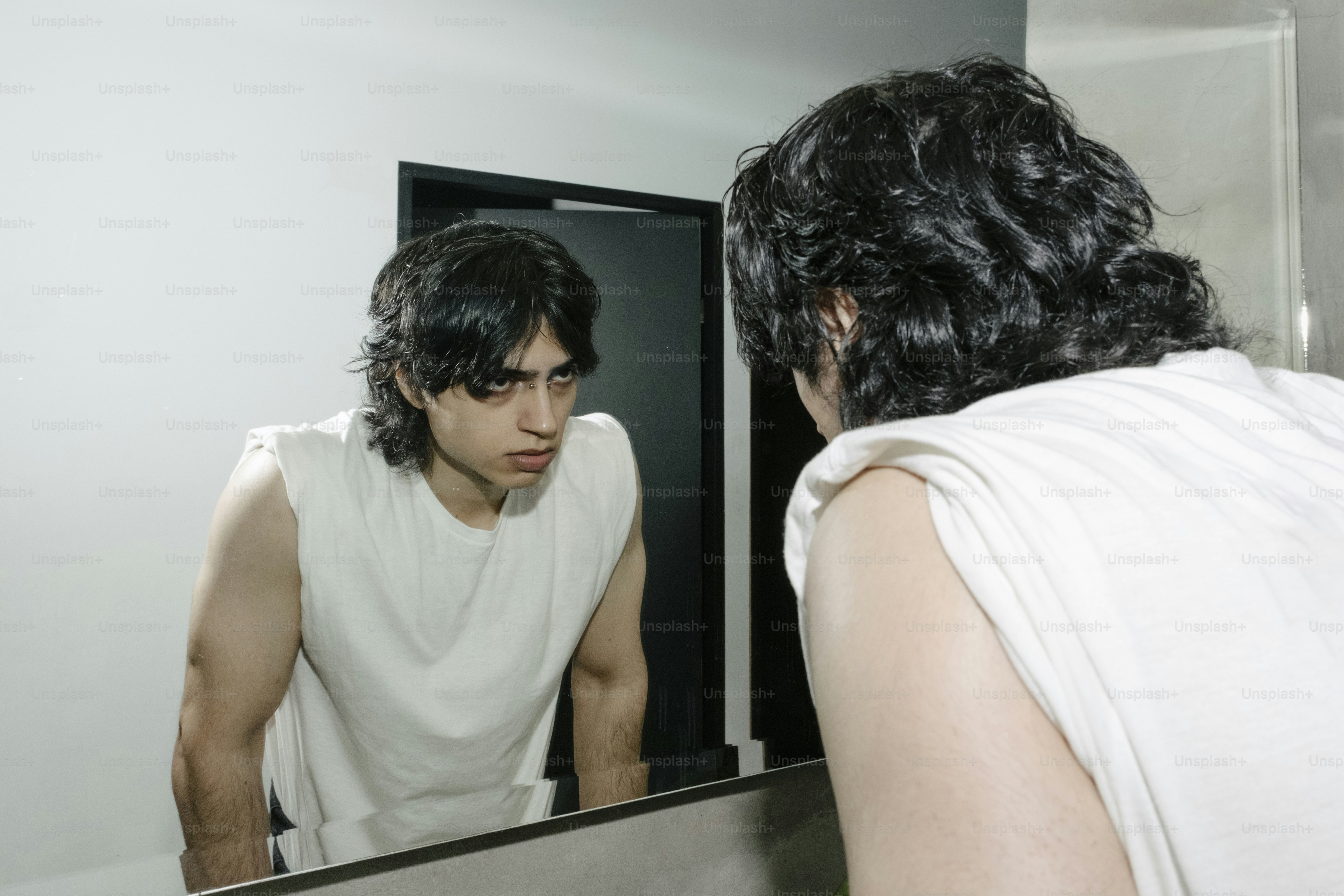 A man looking at himself in the mirror